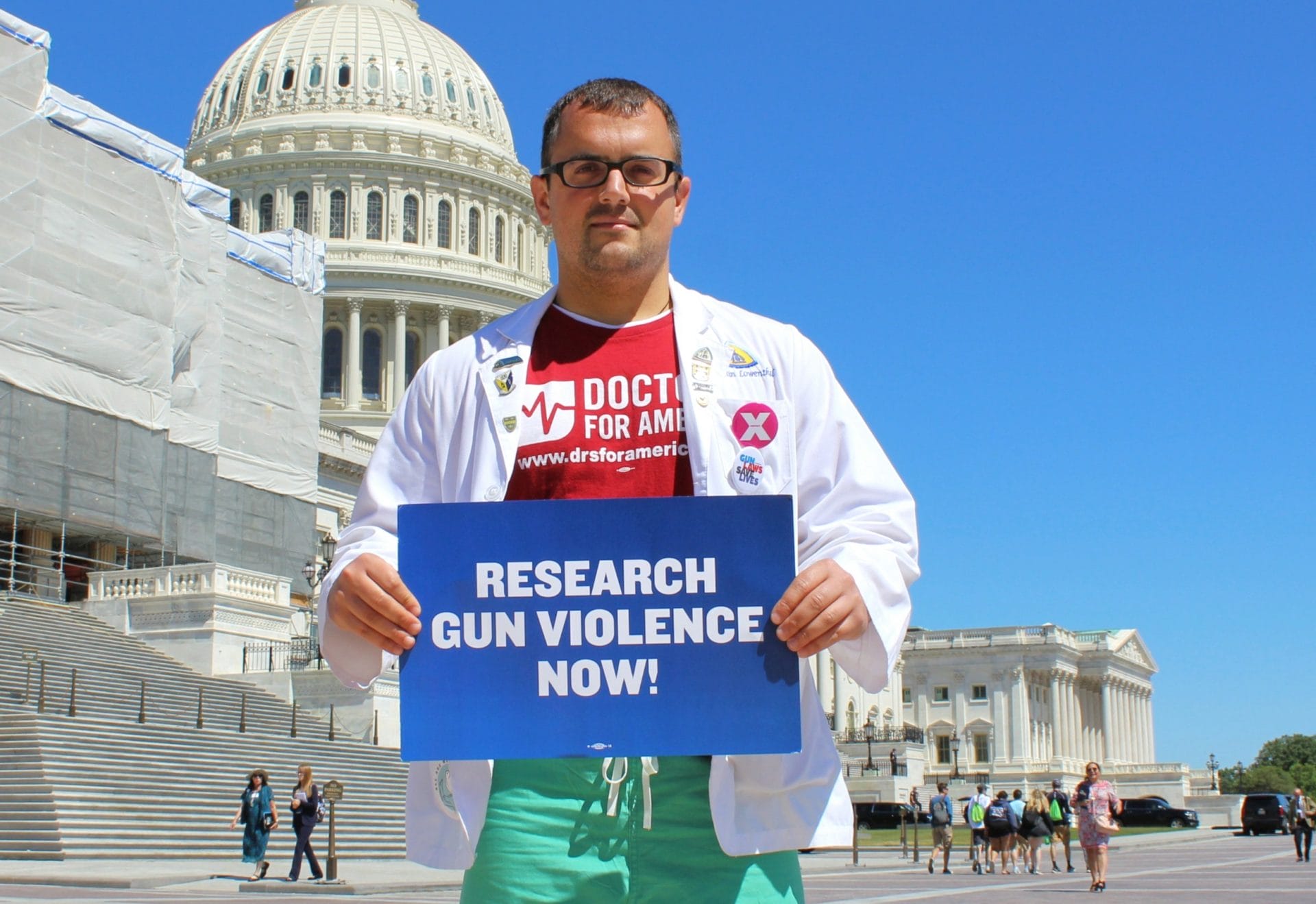 A member of the group Doctors for America stands in front of the U.S. Capitol before a gun violence research press conference. June 11, 2019'Research Gun Violence Now