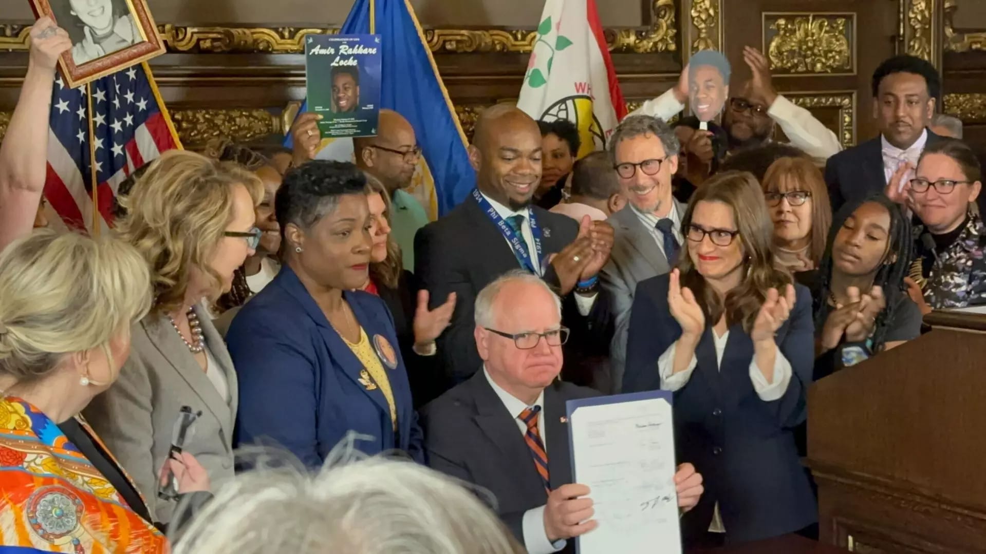 Minnesota Governor Tim Walz signs gun safety legislation on May 19, 2023.